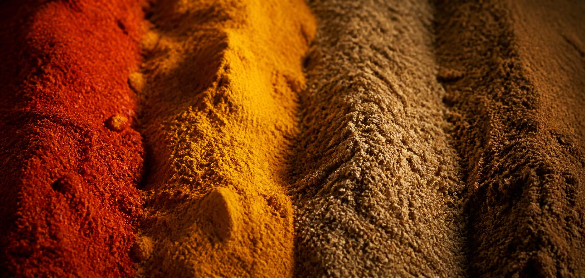 Macro textures of freshly ground chilli, turmeric, coriander and garam masala